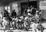 Children stand in front of the food distribution building in Bindermichl DP camp.