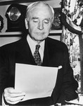 Portrait of Cordell Hull reading a document.