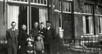 The Drukker family poses outside its home in Winschoten.