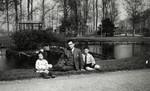 Maurits Drukker poses with his children Elly and Alfred in a park in Winschoten.