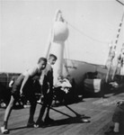 Two German Jewish refugee youth play shuffleboard on the deck of the SS Iberia during the voyage from Lisbon to Havana.