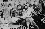 A Jewish refugee family from Germany poses on the deck of the SS Rotterdam while en route to New York.