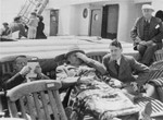 German Jewish refugees relax on the deck of the SS Iberia during the voyage from Lisbon to Havana.