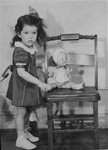 Portrait of the donor, Haviva Kaplan, with a doll in her home in New York.