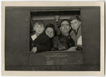 The Galicki family looks out a train window as they leave for the Bremerhaven harbor en route to the United States.