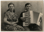 Nathan Rubinstein plays the accordion while his mother sits and listens.