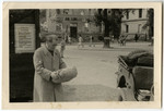 Dr. Hirsch (Tzvi) Elkes stands on a street corner in Germany and examines a package.