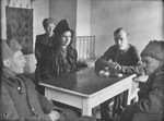 Esther Lurie serves as a translator between freed American POWs and Soviet officers.