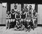 An extended Austrian-Jewish family poses for a family portrait in their bathing suits.