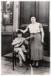 Leah Wajsfelner plays a mandolin while her mother Fajgla stands next to her.