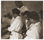 A team of doctors treats an infant in the hospital of the Lodz ghetto.