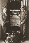 Moryc Brajtbart and his cousin, Leon, stand on either side of a memorial to the 6,500 Jews of Szczercow, who were killed by the Nazis in August, 1942.