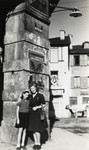 Malvine and Rachelle Reicher (aunts of the donor) pose on a street under an archway in wartime France in a village where they were sent by the local Red Cross..