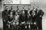 Jewish rabbinical students pose in front of a building.