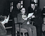 Defendant Vincenz Nohel reads his statement at the Mauthausen war crimes trial.