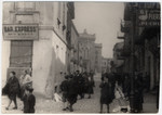 View of a commercial street in Lodz.  

On the left is the bar "Express" which belonged to the donor's grandfather, Michuel Krell, and in the background is the Alteschule [Old Town Synagogue].