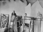 Patients sit in bunk beds in the Kovno ghetto hospital.