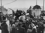 Jews in the Kovno ghetto are boarded onto trucks during a deportation action to either a work camp near Kovno or Estonia.