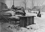 Bedding and furniture piled up on a residential street in the Kovno ghetto.