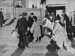 Jewish police direct people to the assembly area in the Kovno ghetto during a deportation action to Estonia.