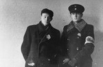 Photographer Zvi-Hirsh Kadushin (George Kadish, left) poses with deputy police chief Yehuda Zupovitz (right) in the Kovno ghetto.