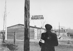 Jewish policeman next to the workshops in the Kovno ghetto once the ghetto had officially become a concentration camp.