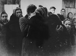 Two women bid each other farewell at an assembly point in the Kovno ghetto during a deportation action to Estonia.