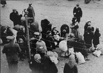 A group of Jews is gathered at an assembly point in the Kovno ghetto during a deportation action.