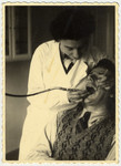 Ella (nee Schapiro) Javorkovsky, the aunt of the donor, performs dentistry on a patient in Riga, Latvia.