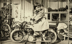 Lisa Rosensweig poses on a small bicycle.