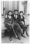 Yehiel Milchberg (brother of the donor) poses with his cousins outside a building in Nasielsk.