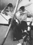 Gerd and Rolf Altschul climb on a ladder on the deck of the St.
