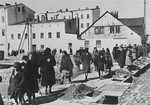 Lodz Jews walk through a courtyard filled with debris a short time before the sealing of the ghetto.