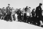 Jewish police escort a group of Jews who have been rounded-up for deportation in the Lodz ghetto.