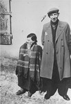 Portrait of a Jewish man and a woman in a street of the Lodz ghetto.