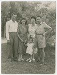 The family of Yehuda and Lola Bielski pose on a grassy lawn in Israel.