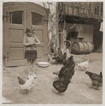 Ruth Wottitzky feeds the chickens outside her home in Windigsteig, Austria.