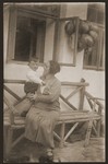 Marie Klepetar sits outside her home with her son, Ivo.