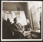 Julius Goldstein stands in front of a desk in his general store.