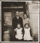 Members of the Goldstein family pose at the entrance to Julius Goldstein's general store in Sevetin.