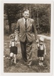 Herbert Guttmann walks outside with his twin children, Rene and Renate.