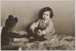 Portrait of one year old Suse Grunbaum with her teddy bear.