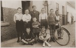 Beno and Gerd Zwienicki (standing first and second on the right) pose in front of their father's bicycle shop with a group of non-Jewish children from the neighborhood.