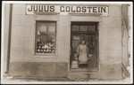 Fanny Goldstein stands at the entrance to the family's general store in Sevetin, Czechoslovakia.