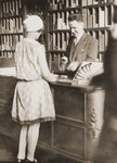 Arthur Lewy confers with a customer in his tobacco store in Berlin.