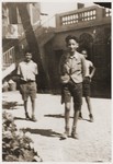 Three Jewish refugees youths stand in the courtyard of the Hotel Bompard transit camp in Marseilles.