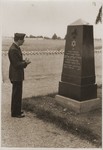 At Dachau, US Army Chaplain Sol Shapiro pays his respects at the grave of former leader of the Kovno Jewish community, Dr.
