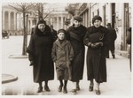 Members of the Tenenbaum family walk along the streets of Warsaw.