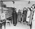 American congressmen view the open ovens in the Buchenwald crematorium.