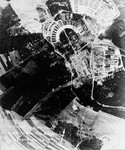 An aerial photograph of Buchenwald concentration camp showing damage inflicted by American bombers on the munitions factory and storage area of the camp.